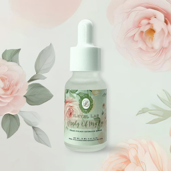 alt="Lash adhesive bonder for lash extensions with apple scent in a clear bottle with floral label on a floral background"