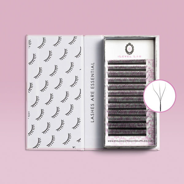 An open tray of iLevel Lab W Shape eyelash extensions containing multi-length rows of black volume lashes on a pink background with a circular graphic showing a close-up diagram of a single W-lash extension for professional lash artists.